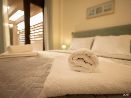 a towel on a bed in a hotel room at Palma Villa & Suite With Pool in Nea Kalikratia