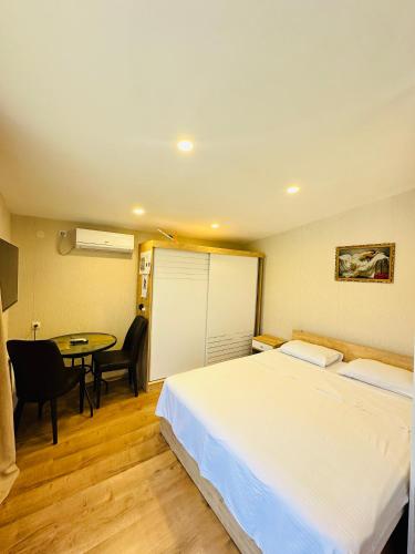a hotel room with a bed and a table at Woodland Borjomi in Borjomi