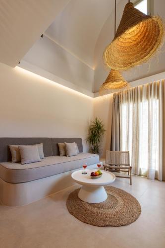 a living room with a couch and a table at Halo Santorini - Living Experience in Fira