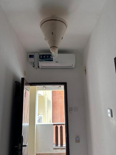 a ceiling with a light and a mirror in a room at Ocean Blue in Ukunda
