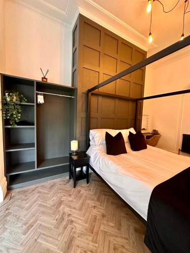 a bedroom with a large white bed and a table at No1,luxury 1 bed apartment in Saint Annes on the Sea