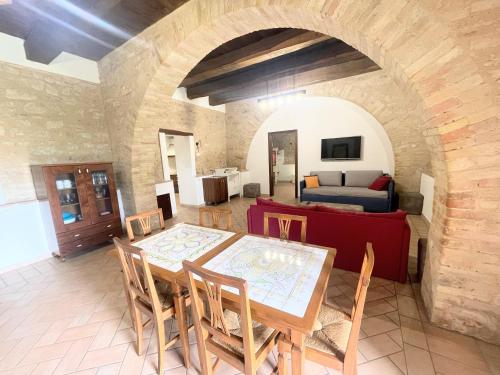 a living room with a table and a couch at Fab villa with fenced pool, huge grounds, meditation park, child activity park in Limiti