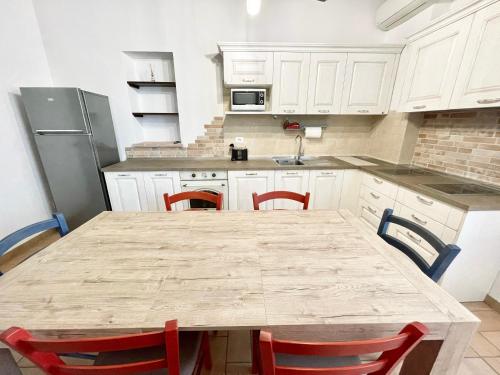 a kitchen with a large wooden table and chairs at Fab villa with fenced pool, huge grounds, meditation park, child activity park in Limiti
