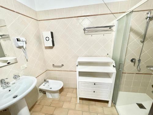 a bathroom with a sink and a toilet and a shower at Fab villa with fenced pool, huge grounds, meditation park, child activity park in Limiti
