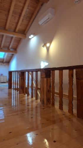 a wooden railing in a room with a wooden floor at El Zaguan in Sotillo de la Adrada