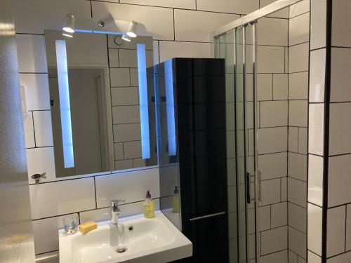 une salle de bain avec un lavabo et une douche en verre dans l'établissement Cap d'Agde, au Cap d'Agde