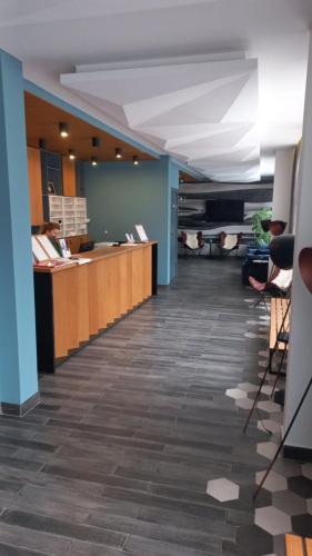 an office lobby with a reception desk and chairs at Apartman 22, Brzeće Centar in Mramor