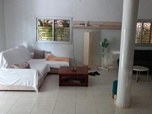 a living room with a couch and a table at Berlin in Ziguinchor