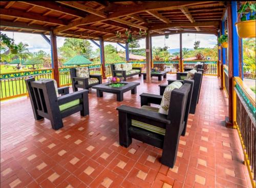 a group of chairs and tables on a patio at Finca Hotel El Ocaso in Quimbaya