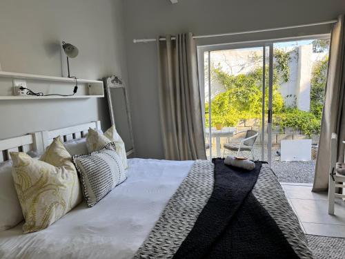 a bedroom with a bed and a door to a patio at Studio #2 in East London