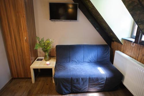 a blue bean bag chair in a room with a table at Villa Biesisko Przysłup Cisna in Cisna