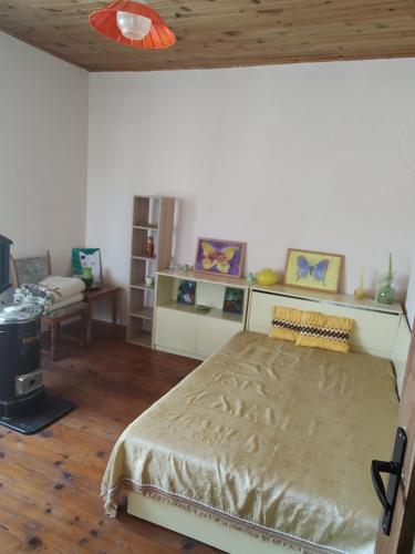 a bedroom with a large bed and a couch at Villa Lavandula in Malko Trŭnovo