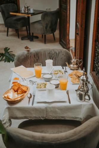 a table with breakfast foods and drinks on it at Riad Djebel in Marrakech