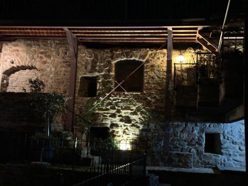 a stone building with lights on it at night at Castello di Francocci Spoleto in Marzolini