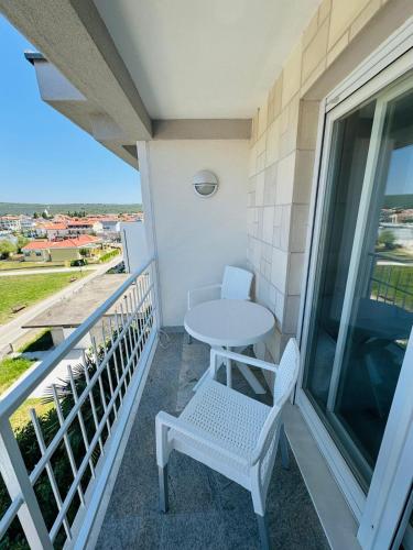 a patio with a table and chairs on a balcony at Rooms and Apartments Zara in Sukošan