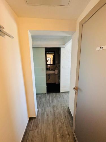 an empty hallway with a door and a kitchen at Rooms and Apartments Zara in Sukošan