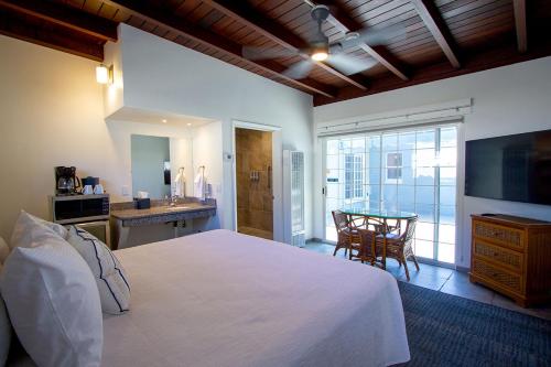 a bedroom with a large white bed and a table at Edgewater Beach Inn in Santa Cruz