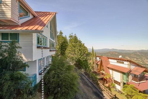 a group of houses on the side of a hill at New-CasitaDeLasFlores-View-Wifi-Jacuzzi-Jarabacoa in Jarabacoa