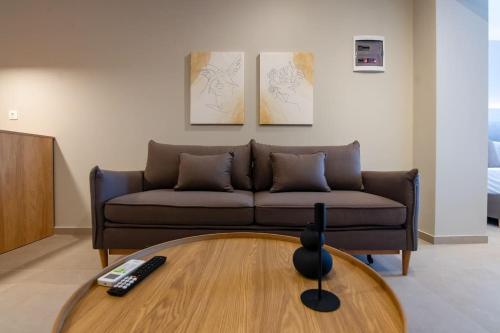 a living room with a couch and a coffee table at Luxury central apartment 6,2 in Larisa