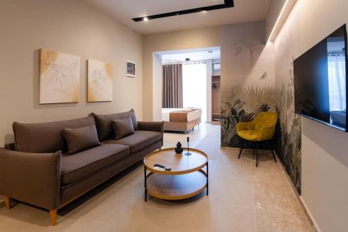 a living room with a couch and a coffee table at Luxury central apartment 6,2 in Larisa