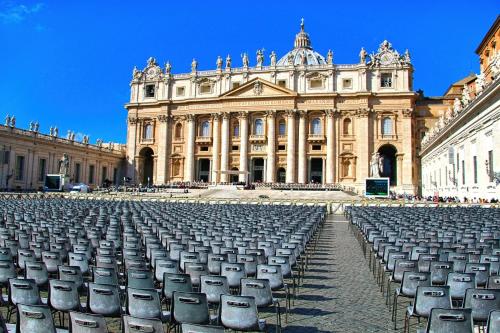 a large building with rows of chairs in front of it at Vatican R(h)ome in Rome