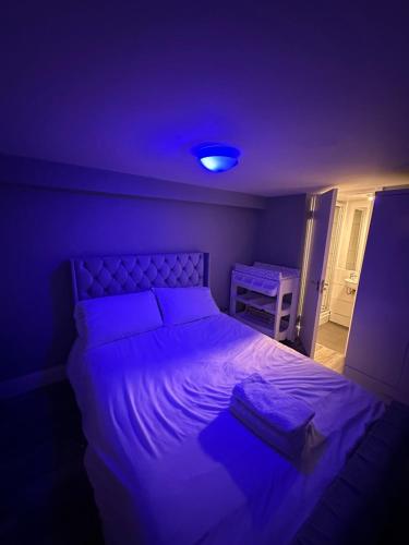 a bedroom with a large bed with a blue light at Entire Apartment in Dublin in Dublin