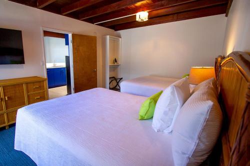 a hotel room with two beds and a television at Edgewater Beach Inn in Santa Cruz