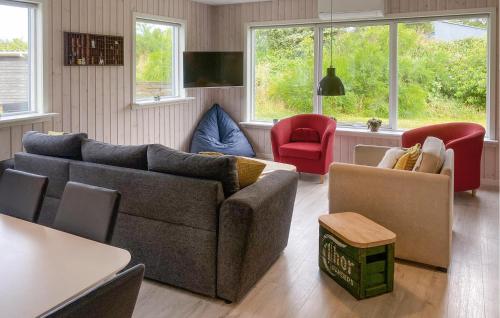 a living room with a couch and chairs and windows at 3 Bedroom Nice Home In Skjern in Skjern