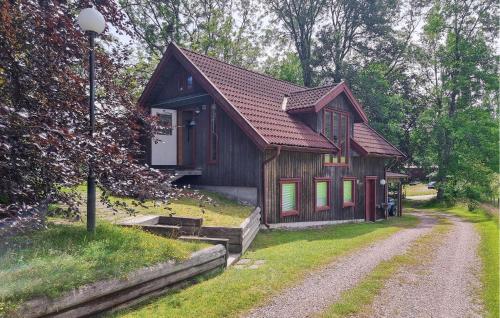 a small wooden house on a dirt road at 1 Bedroom Awesome Home In Västerlanda in Västerlanda