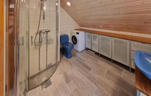 a bathroom with a toilet and a washing machine at 1 Bedroom Awesome Home In Västerlanda in Västerlanda