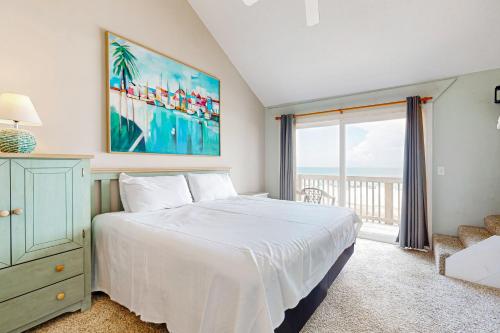 a bedroom with a bed and a large window at The Breeze in Gulf Shores