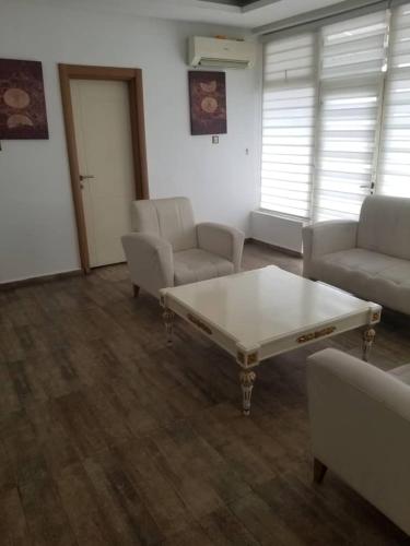 a living room with a couch and a coffee table at Ellyxville Hotel in Lekki