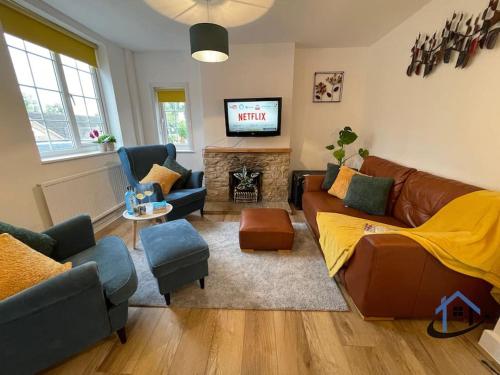 a living room with a couch and a television at Petham Cottage Stanwick 2 bed sleeps 6 in Stanwick
