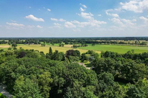 an aerial view of a field and trees at Modern huisje op de Veluwe in Epe