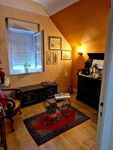 a living room with a table and a window at chambre d'hôtes avec petit déjeuner compris à Mégrit in Mégrit