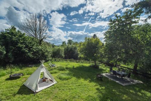 a tent in the middle of a grass field at Romantická Chalupa Louka in Louka