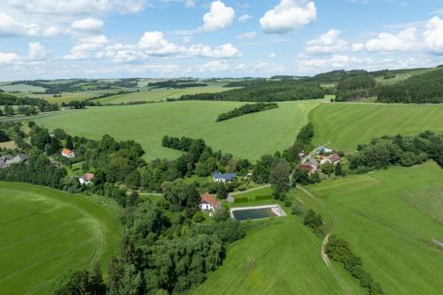 an aerial view of a house in a green field at Romantická Chalupa Louka in Louka