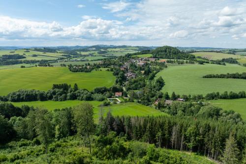 an aerial view of a village in a green field at Romantická Chalupa Louka in Louka