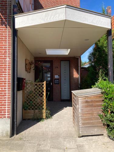 awning over the entrance to a brick building at Kom tot rust in The Forest in Putte