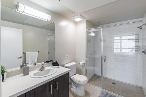 a bathroom with a toilet and a sink and a shower at 2 Bed 2 Bath X street LA Live, Convention Center, Microsoft Theater in Los Angeles