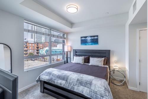 a bedroom with a bed and a large window at 2 Bed 2 Bath X street LA Live, Convention Center, Microsoft Theater in Los Angeles