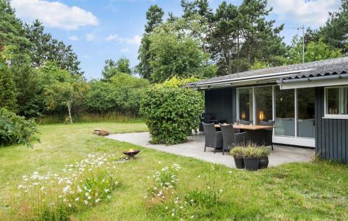 a small house with a patio and a garden at 2 Bedroom Cozy Home In Nykøbing Sj in Nykøbing Sjælland