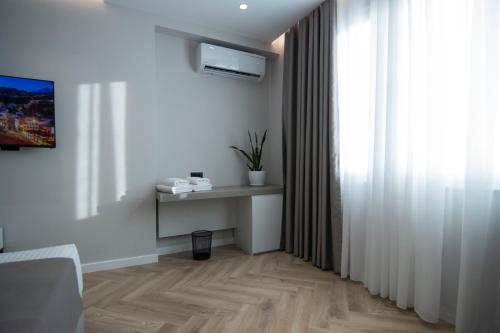 a living room with a table and a window at Mina Luxury Rooms in Tirana