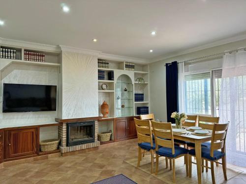 a dining room with a table and a fireplace at Villa Victoria - Ole Solutions in El Puerto de Santa María