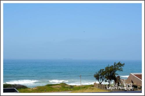 a view of the ocean from a beach at Golden Dawn Chalets in La Mercy