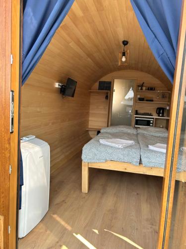 a small room with a bed in a tent at Zatoka Marina II in Mechelinki