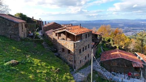an old building on the side of a hill at Telhados de Xisto in Lousã