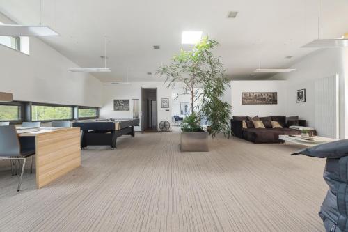 a large living room with a couch and a piano at Hollywood Dream in Knínice u Boskovic
