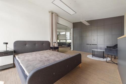 a bedroom with a large bed and a table at Hollywood Dream in Knínice u Boskovic
