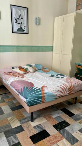 a bed sitting in a room with at Cuneo Centro Affittacamere in Cuneo
